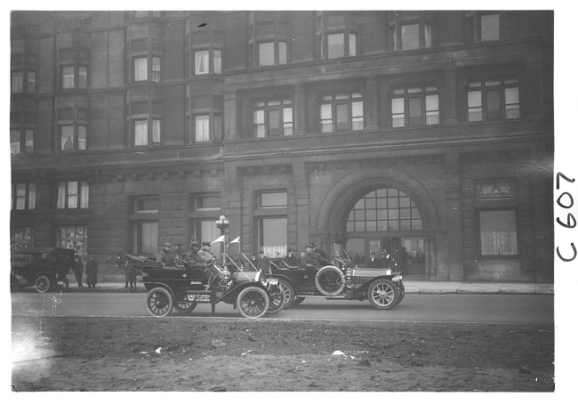 E.M.F. car next to large, stone building, on pathfinder tour for 1909 Glidden Tour