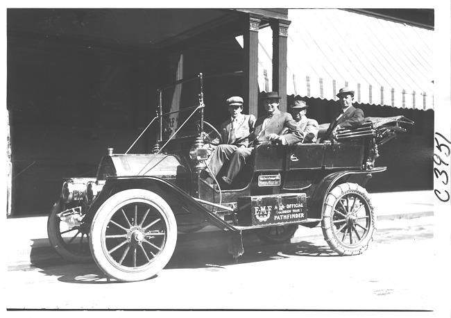 E.M.F. car by striped awning, on pathfinder tour for 1909 Glidden Tour