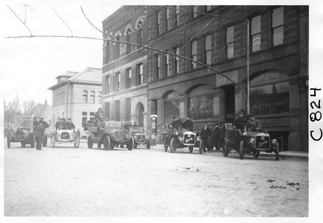 E.M.F. car by newspaper building, on pathfinder tour for 1909 Glidden Tour