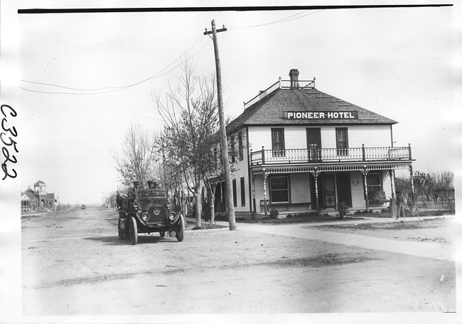 E.M.F. car  passing Pioneer Hotel, on pathfinder tour for 1909 Glidden Tour