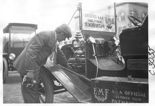 E.M.F. car with man checking engine, on pathfinder tour for 1909 Glidden Tour