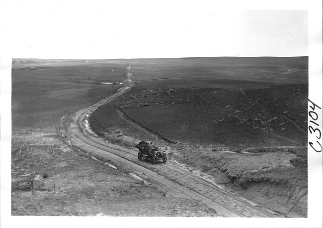 Bird's-eye view of E.M.F. car on rural road, on pathfinder tour for 1909 Glidden Tour
