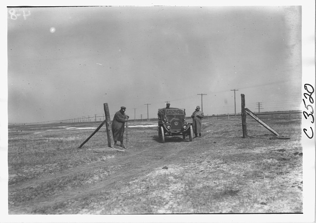 E.M.F. car stopped at barbed wire gate, on pathfinder tour for 1909 Glidden Tour
