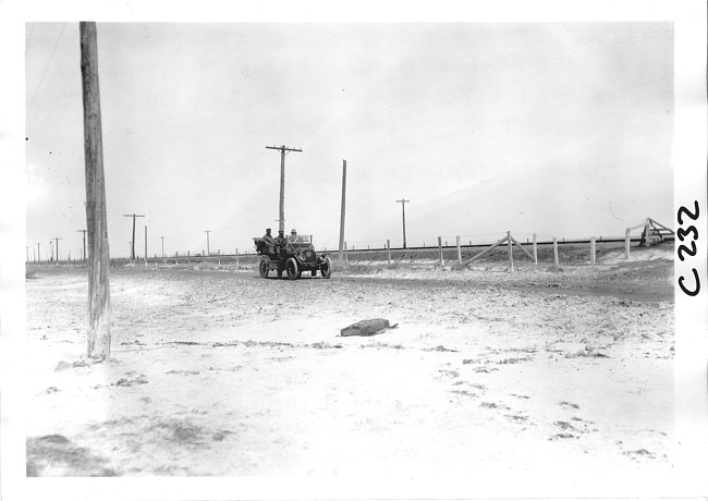 E.M.F. car on rural road with telephone poles, on pathfinder tour for 1909 Glidden Tour