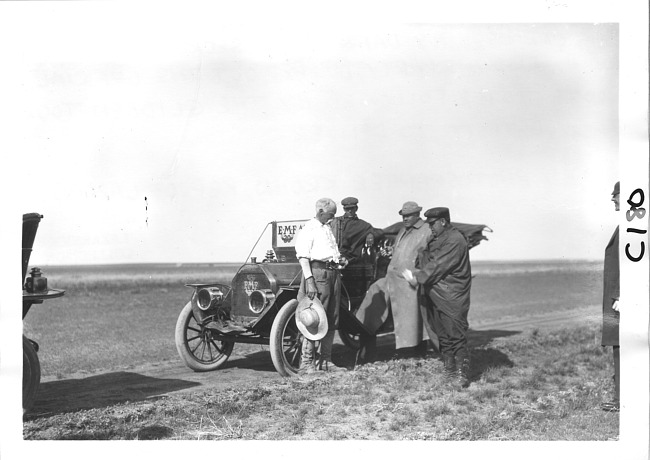 Dai Lewis stands near E.M.F. car with other men, on pathfinder tour for 1909 Glidden Tour