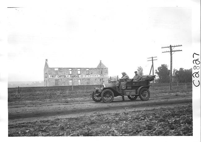 E.M.F. car passing First Capitol of Kansas building, on pathfinder tour for 1909 Glidden Tour