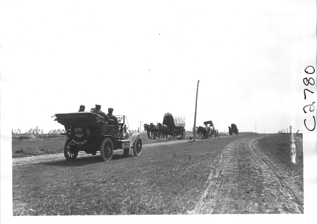E.M.F. car encounters covered wagons along rural road, on pathfinder tour for 1909 Glidden Tour