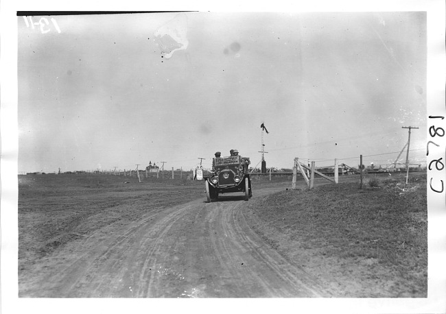 E.M.F. car rounding a corner on rural road, on pathfinder tour for 1909 Glidden Tour