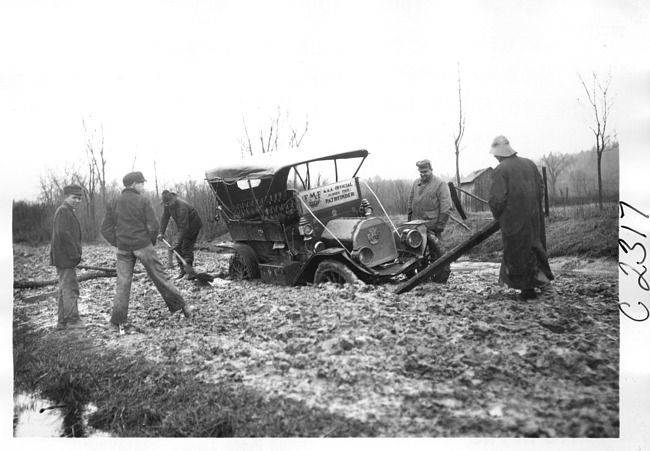 E.M.F. car stuck in the mud, on pathfinder tour for 1909 Glidden Tour