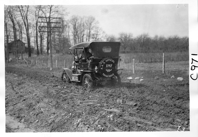 E.M.F. car on muddy road, on pathfinder tour for 1909 Glidden Tour