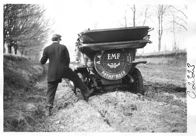 E.M.F. car in ruts on muddy road, on pathfinder tour for 1909 Glidden Tour
