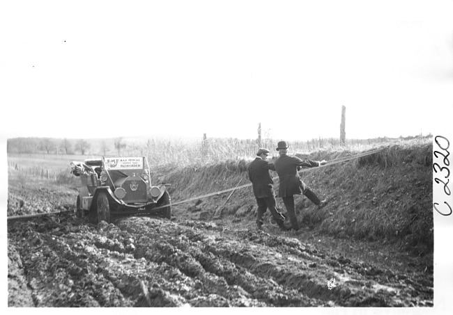 E.M.F. car stuck in mud, on pathfinder tour for 1909 Glidden Tour