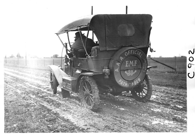 E.M.F. car traveling on muddy road, on pathfinder tour for 1909 Glidden Tour