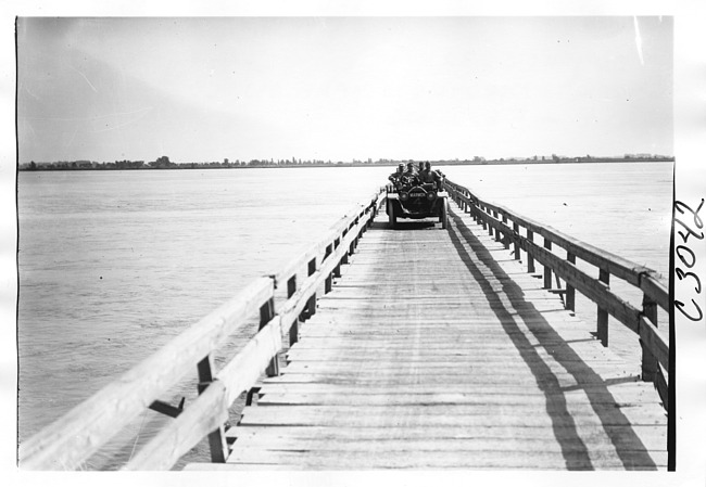 E.M.F. car crossing wooden bridge, on pathfinder tour for 1909 Glidden Tour