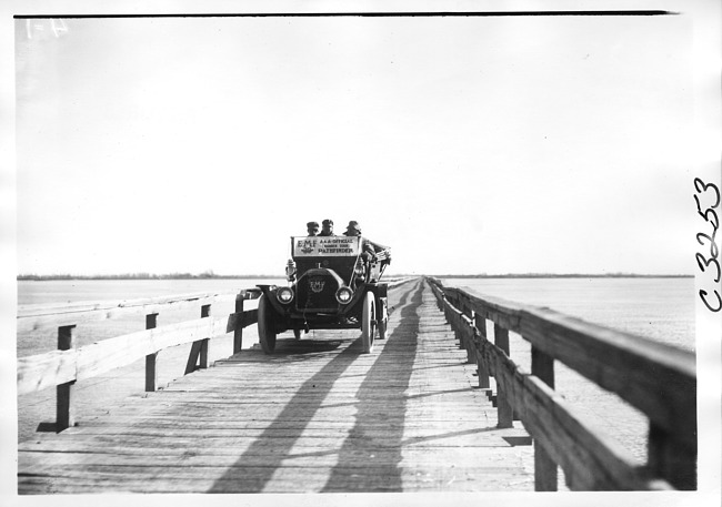 E.M.F. car crossing wooden bridge, on pathfinder tour for 1909 Glidden Tour