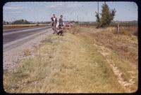 Three men, including Jim Watson, examine saltgrass along a roadway in Colorado, 1955
