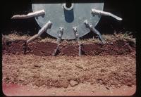 Soil layer cross-section image of how drum aerifier spoons enter and exit a soil profile