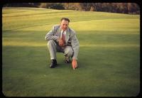 Golf course superintendent Bill Beresford points out the spot on the green of the 12th hole at the Los Angeles Country Club where "LA Bent" was selected out of Seaside turf in 1941